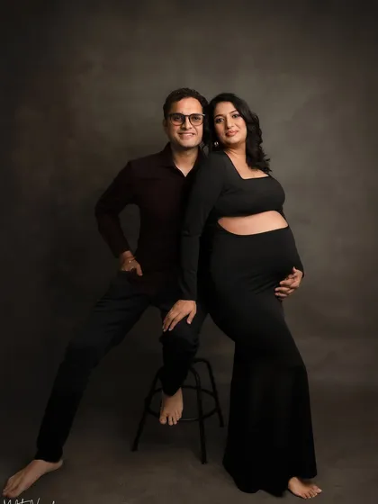 A classic studio portrait with the couple in matching black. This creates a sleek, modern, and unified look.