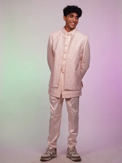 A full-length view of the pastel pink Indo-Western set. The modern silhouette and soft color make it a fresh choice for a daytime wedding or festive event.