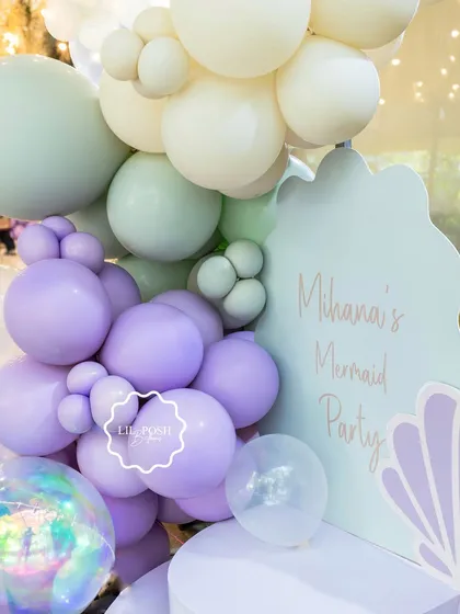 A detailed shot of the pastel balloon arrangement for the mermaid party welcome sign.