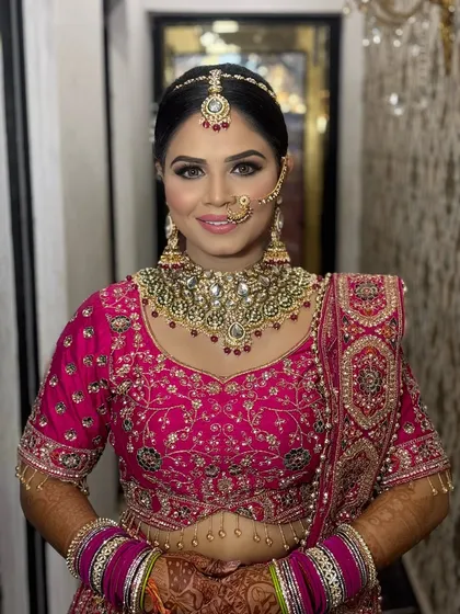A happy bride showcasing her final look. The smile says it all. The makeup is set to last all day, ensuring she looks fresh and radiant throughout the celebrations.