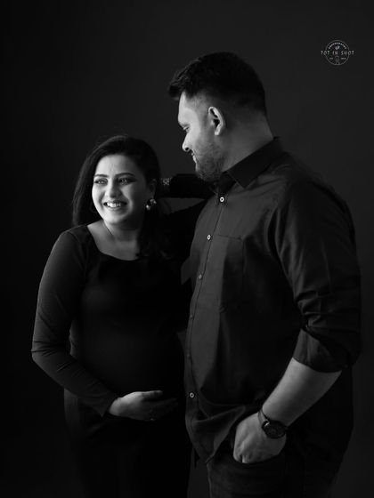 A joyful black and white couple's portrait, capturing a candid moment of laughter and love.