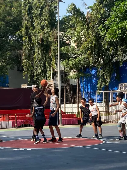 A tense moment under the basket during a junior league game. These experiences build character and a love for competition.