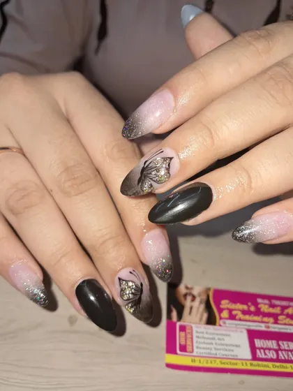 A still image of the beautiful and moody butterfly nail art with a black and grey ombre effect.