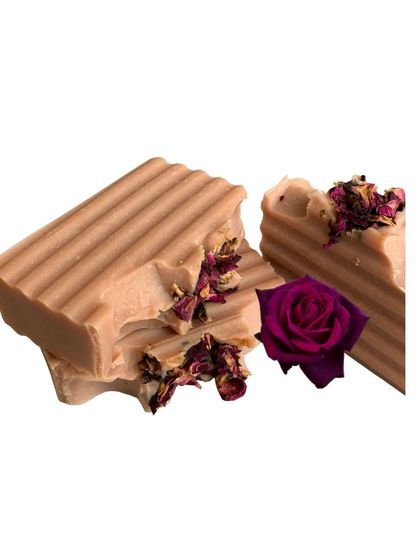A stack of my Rose Pink Clay soap bars, topped with delicate dried rose petals. This vegan soap is made with a blend of olive, coconut, and castor oils.