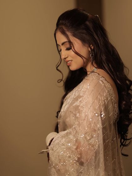 A profile shot that highlights the soft curls and the delicate eye makeup. This look was all about understated elegance, perfect for her engagement ceremony.