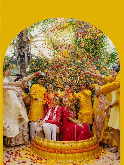 The pure, unadulterated joy of a Haldi ceremony. We love capturing these candid moments of celebration, where friends and family shower the couple with love and vibrant flower petals.