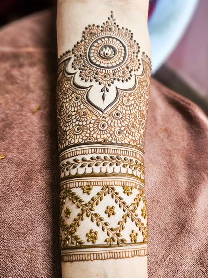 A close-up of the armband, featuring a delicate lotus mandala and vine patterns.