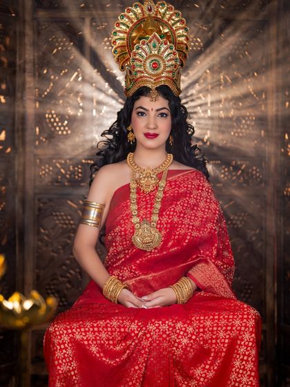 A direct, powerful portrait from the Varamahalakshmi shoot. The lighting highlights the golden tones in the makeup and the intricate details of the crown.