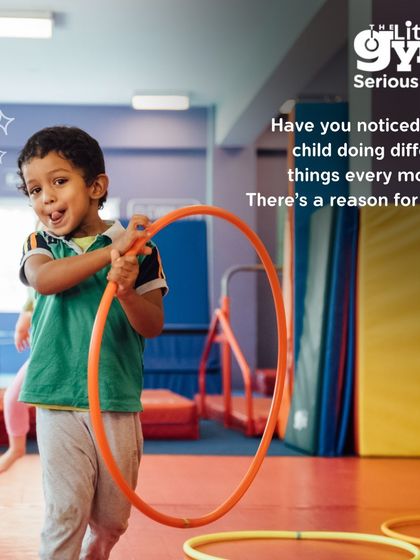 A preschooler enjoys a moment of fun with a hula hoop. Our monthly themes introduce new skills and challenges, keeping children engaged while they master body control and coordination.