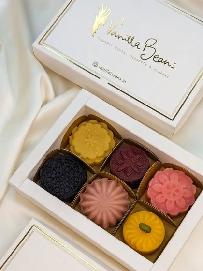 The elegant packaging for our Cake Mithai, featuring our signature white and gold foil box that makes for a luxurious festive gift.