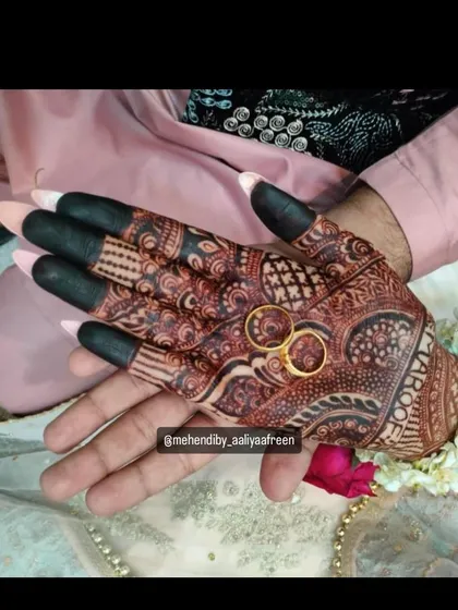 Capturing the engagement vibes with this groom's mehendi, featuring the couple's rings as a centerpiece.