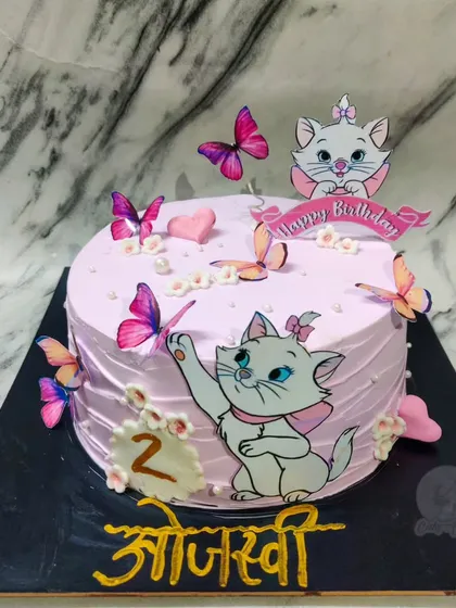 A purr-fectly cute kitty cake for a 2nd birthday. This one features Marie from The Aristocats, surrounded by pretty pink butterflies.