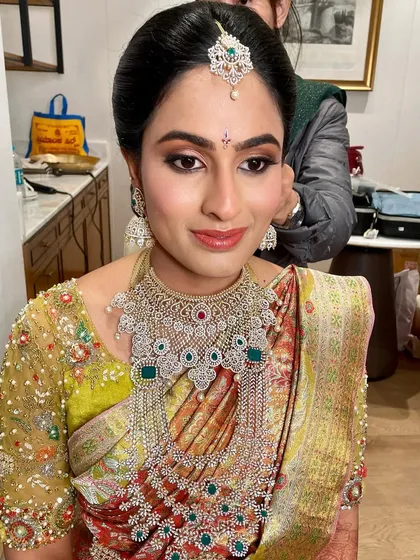 A close-up portrait showing the flawless application and the way the makeup enhances her beautiful features.