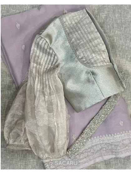 A full view of the statement silver blouse with its voluminous sleeves, paired with a delicate lavender saree.