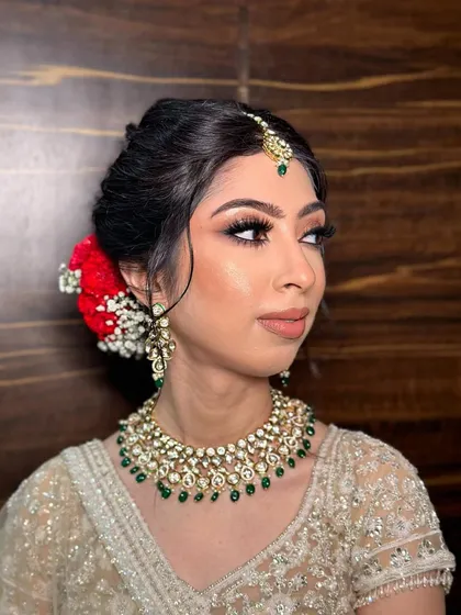 A side profile of Kanika, highlighting her flawless skin and the elegant hairstyle that completes her phera look.