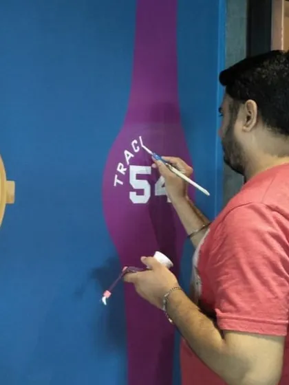 Here you can see me adding the fine details to a watch mural. Every part of the process is done by hand with a fine brush to ensure the final artwork is sharp, accurate, and truly a piece of custom art.