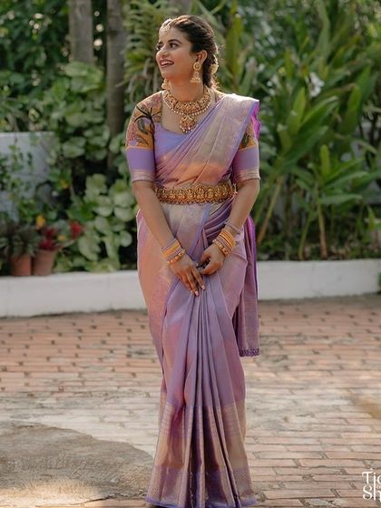 A full-length shot of the lavender saree, showing how the printed blouse sleeves add a contemporary and artistic flair to the traditional outfit.