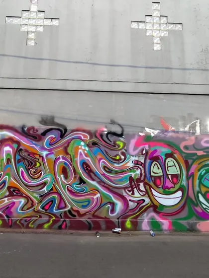 A long wall featuring a mix of my psychedelic lettering and trippy, smiling character faces. This piece is all about creating a fluid, melting effect.