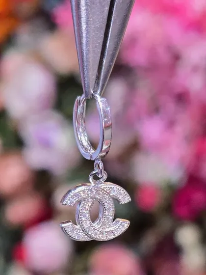 A classic logo-inspired hanging from a simple hoop, offering a touch of designer-inspired elegance.