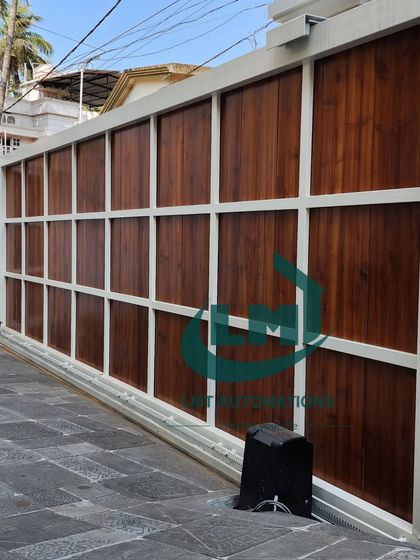 The completed installation of a large, wood-paneled cantilever gate. The powerful motor and robust hardware ensure it operates smoothly despite its size and weight.