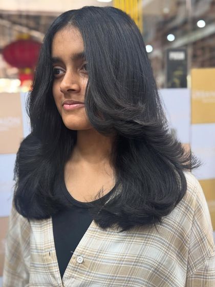 A chic and modern layered haircut that adds volume and shape. It's a versatile look that can be styled in many ways.