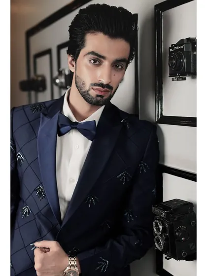 Detail is everything. This close-up showcases the handcrafted embellishments on a navy blue tuxedo, where each element is carefully placed to create a subtle yet striking pattern, reflecting our passion for unique and personalized formal wear.