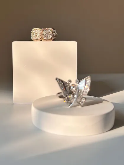 This image showcases two of my favorite rings: a delicate diamond butterfly and a bold, multi-row diamond band. Both are striking pieces that will last forever.