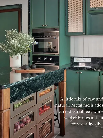 This image shows a mix of raw and natural textures. The industrial feel of the metal mesh drawers on the island is balanced by the earthy, cozy vibe of the wicker panels on the upper cabinets.