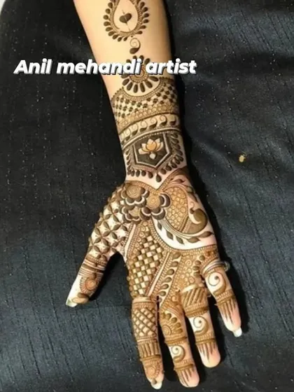 A stylish and intricate design for the back of the hand. The pattern combines a central heart shape with lotus motifs and detailed grid work.