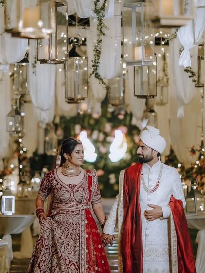 A romantic couple entry, walking hand-in-hand through a magical tunnel of lights and lanterns that we designed for their special night.