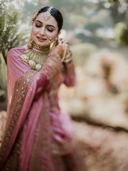 Another artistic shot focusing on the bride's serene expression and the intricate details of her jewelry and makeup.