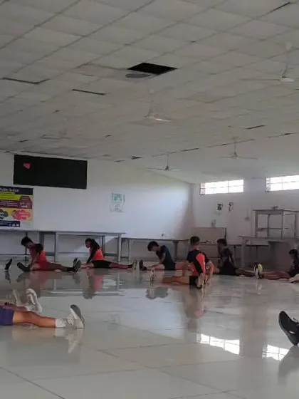 My players focusing on their stretches during an indoor session, ensuring they are prepared for the physical demands of the game.