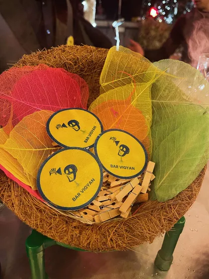 A basket of our custom-branded coasters and colorful leaf garnishes. These small details help reinforce our brand and add a professional touch to any event.