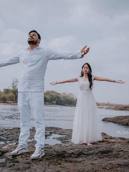 A wide shot of the couple with their arms outstretched, embracing the moment. This photo has a wonderful sense of freedom and joy.