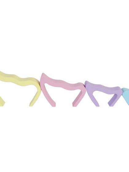 A set of pastel-colored wooden butterfly wing arch toys, disassembled to show each piece.