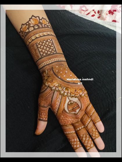 A classic and elegant design for a guest, featuring a central mandala on the palm. The wrist is adorned with a lotus cuff and traditional patterns, creating a balanced and beautiful look.