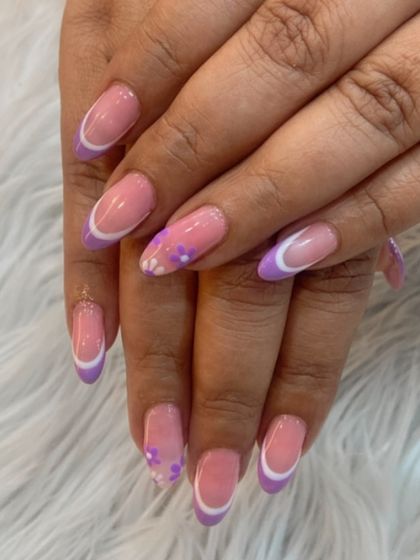 A lovely lavender-colored French tip with small floral details. A perfect way to add a bit of color to a classic design.