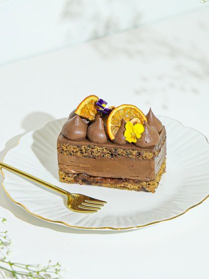 A beautiful slice of our orange and chocolate pastry, a perfect single-serving treat available for delivery.