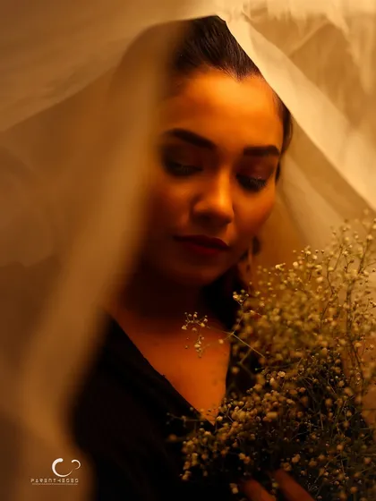 A soft and pensive moment. Her downward gaze and the diffused light create a quiet, contemplative atmosphere.