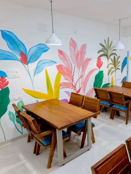 Another view of the tropical wall art in the cafe, showing how it brightens the entire dining area.