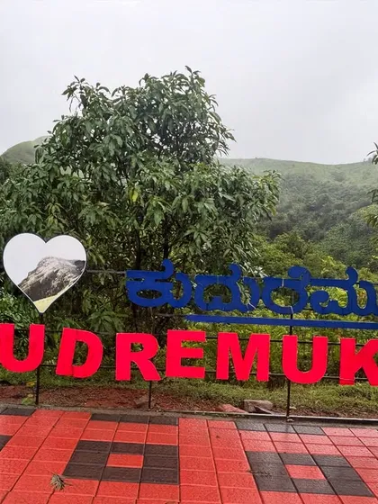A group of friends at the "I Love Kudremukh" sign, a classic photo spot.