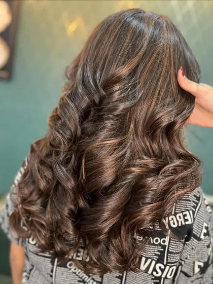 A closer look at the details in this chocolate-coloured hair. You can see subtle lighter brown pieces that add dimension and shine.