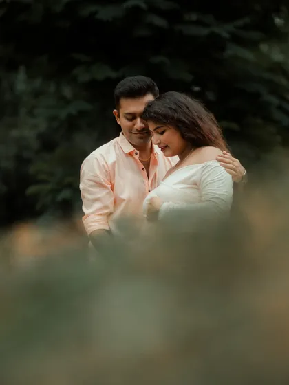 An artistic and intimate portrait of the couple, framed by foliage. I use natural elements to create depth and romance in my photos.