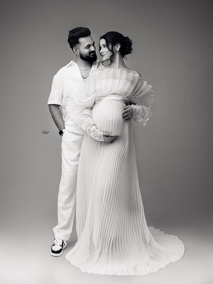 The same loving pose in timeless black and white. This edit really emphasizes the emotional connection and the beautiful textures of their outfits.