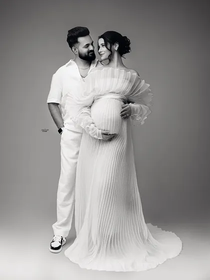 The same loving pose in timeless black and white. This edit really emphasizes the emotional connection and the beautiful textures of their outfits.