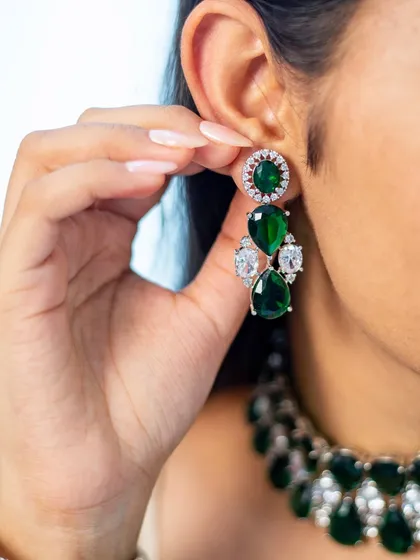 The matching drop earrings to our emerald and zircon choker. These earrings are substantial enough to be worn on their own for a touch of glamour, or paired with the necklace for a full statement look.