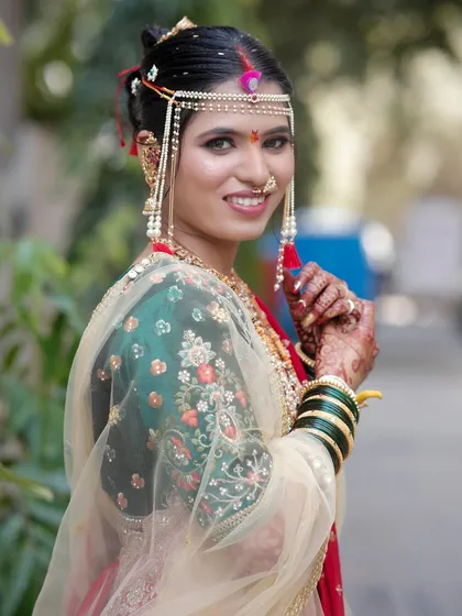 A close-up of my bride Karishma, showcasing her radiant smile and the traditional Maharashtrian jewellery, including the nath and ear cuffs.