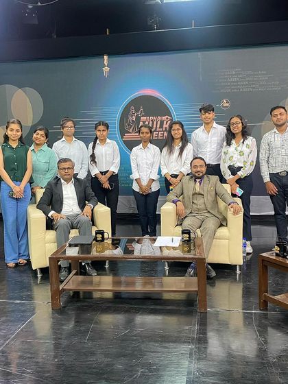 A group photo with law students and the host after filming a TV program on legal topics.