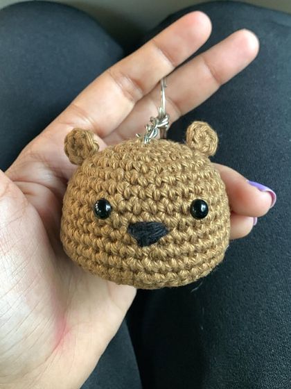 Another angle of the bear keychain, showing its neat, tight stitches which make it durable for everyday use.