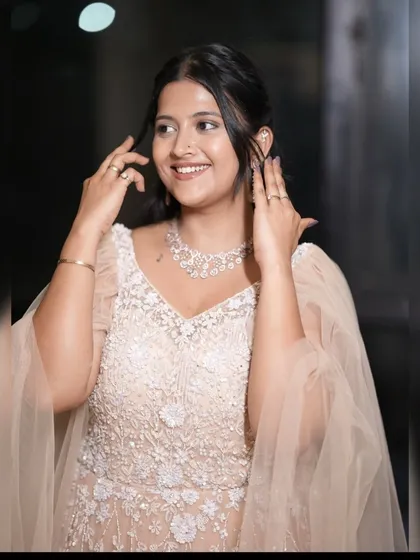 A close-up of the client in the peach gown, smiling and happy.